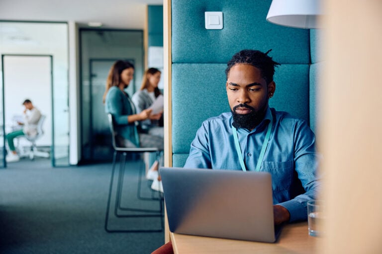 Man working on laptop in a modern office
