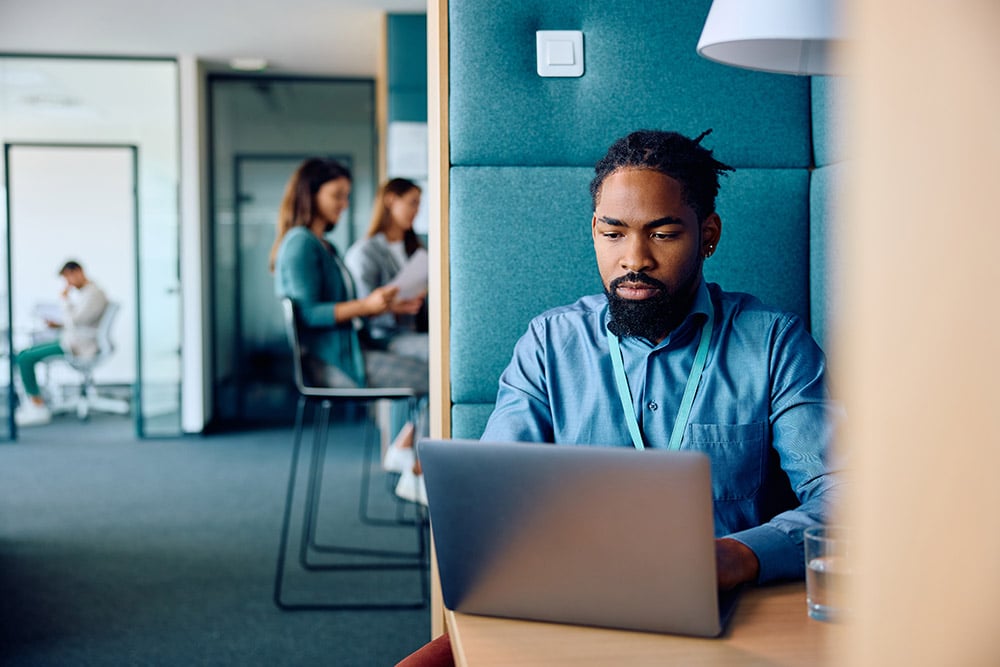 Man working on laptop in a modern office